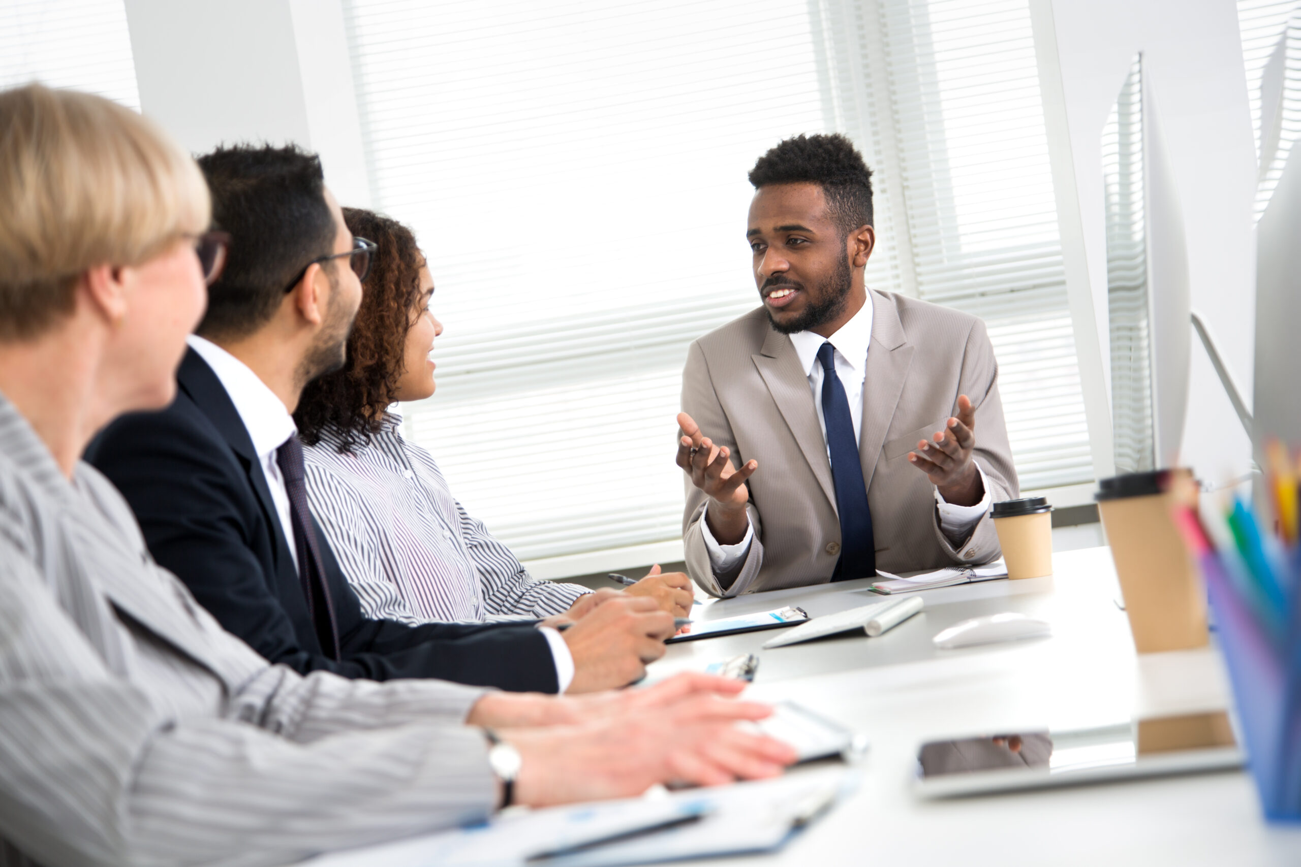 Sales professional delivering a pitch to clients face-to-face