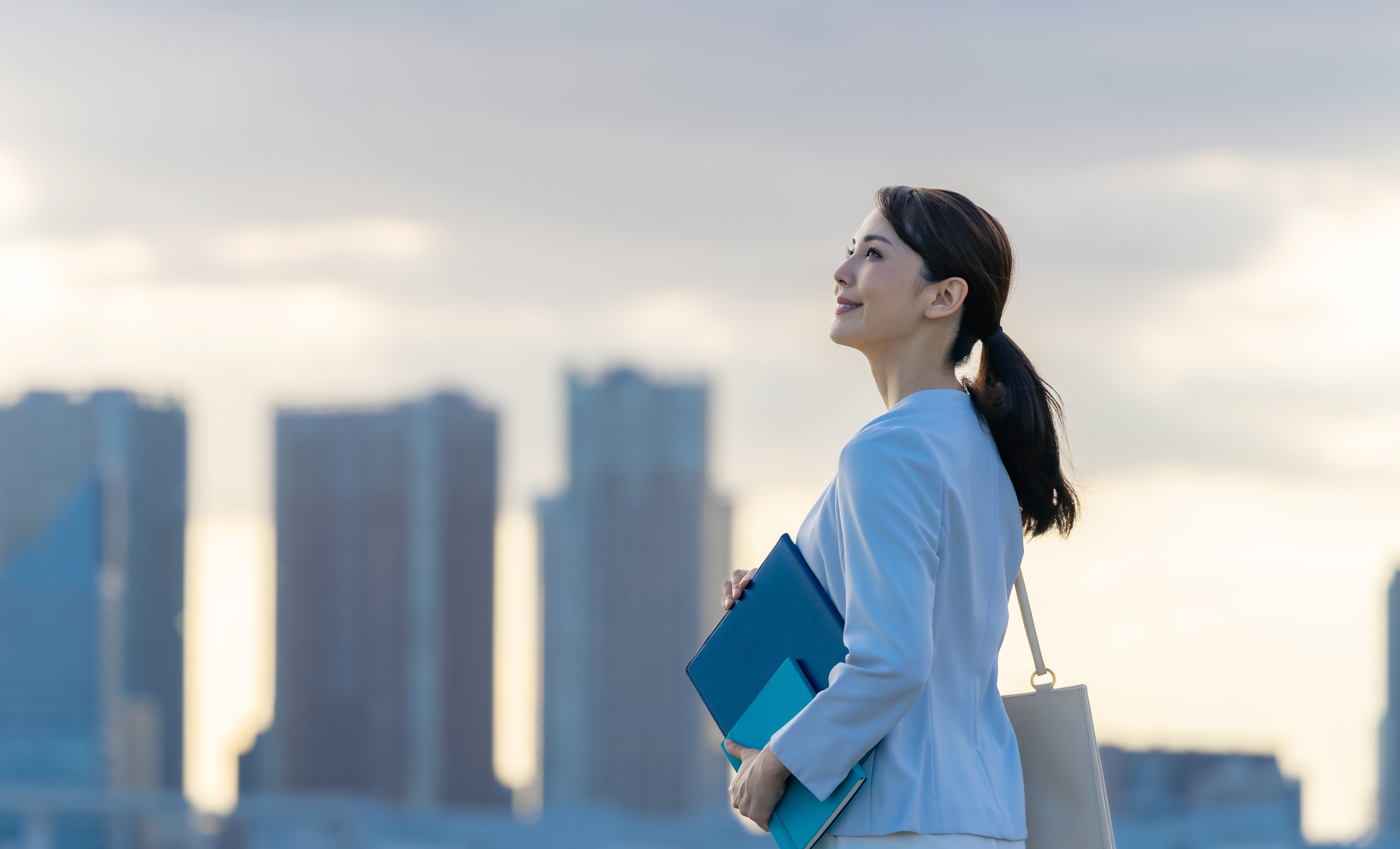Young direct marketing professional looking up and feeling positive