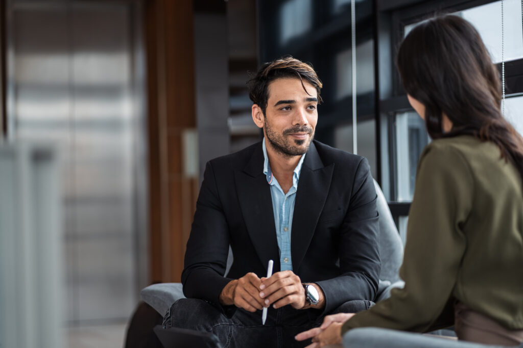A sales professional listening intently as his client discusses her needs.